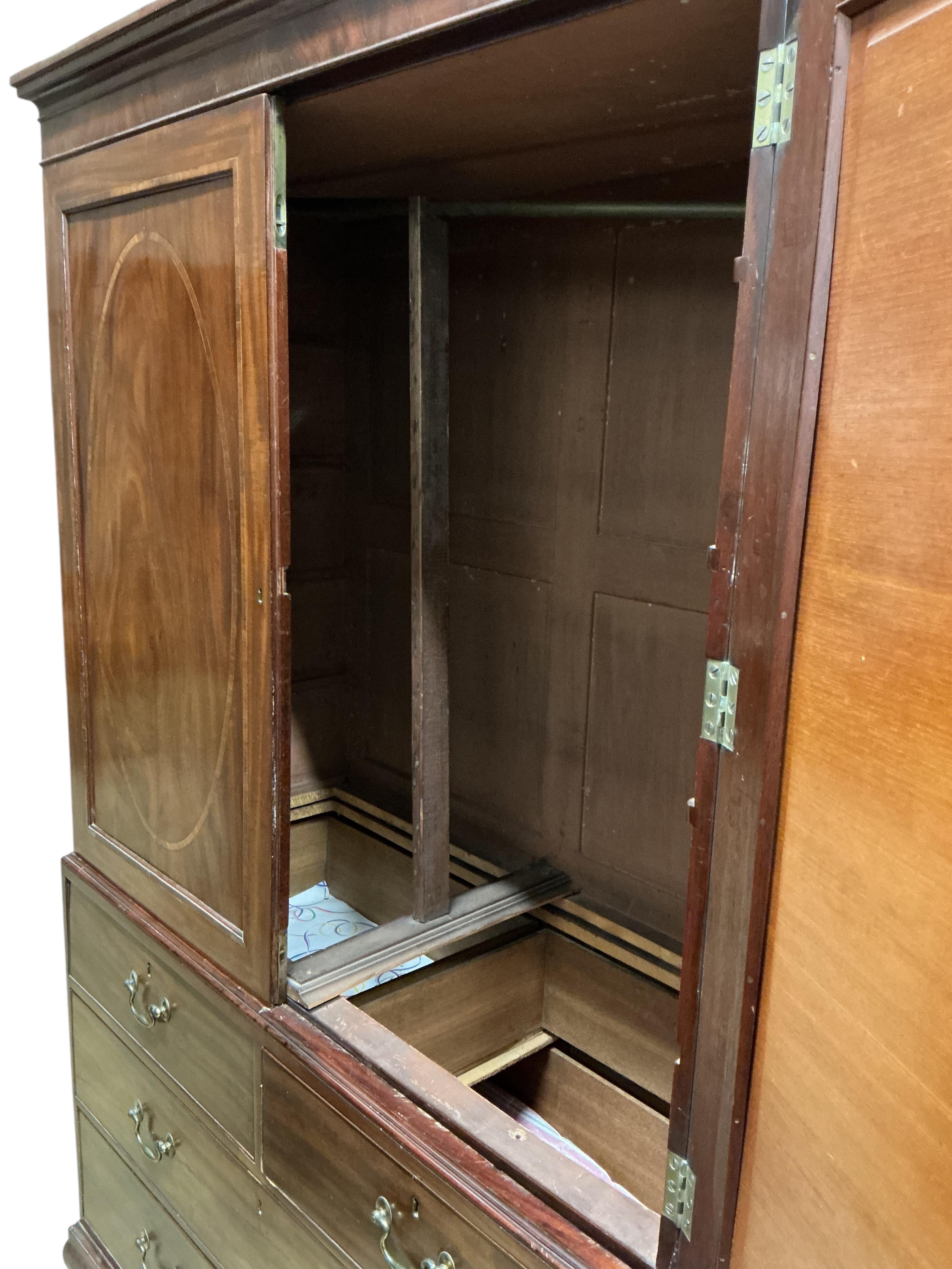 A George III satinwood banded mahogany linen press, converted to a hanging wardrobe, width 126cm, depth 55cm, height 206cm